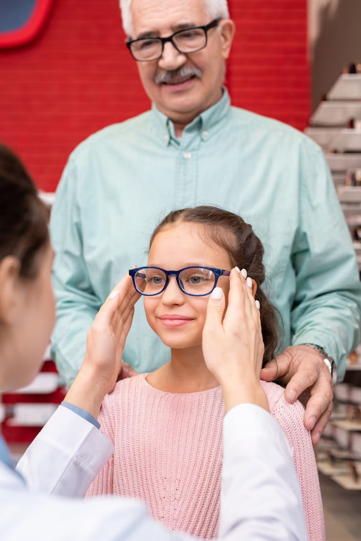 imgi_70_young-female-optician-putting-pair-new-eyeglasses-face-cute-little-girl-visiting-ophthalmological-office-clinics-with-her-grandfather_274679-1962