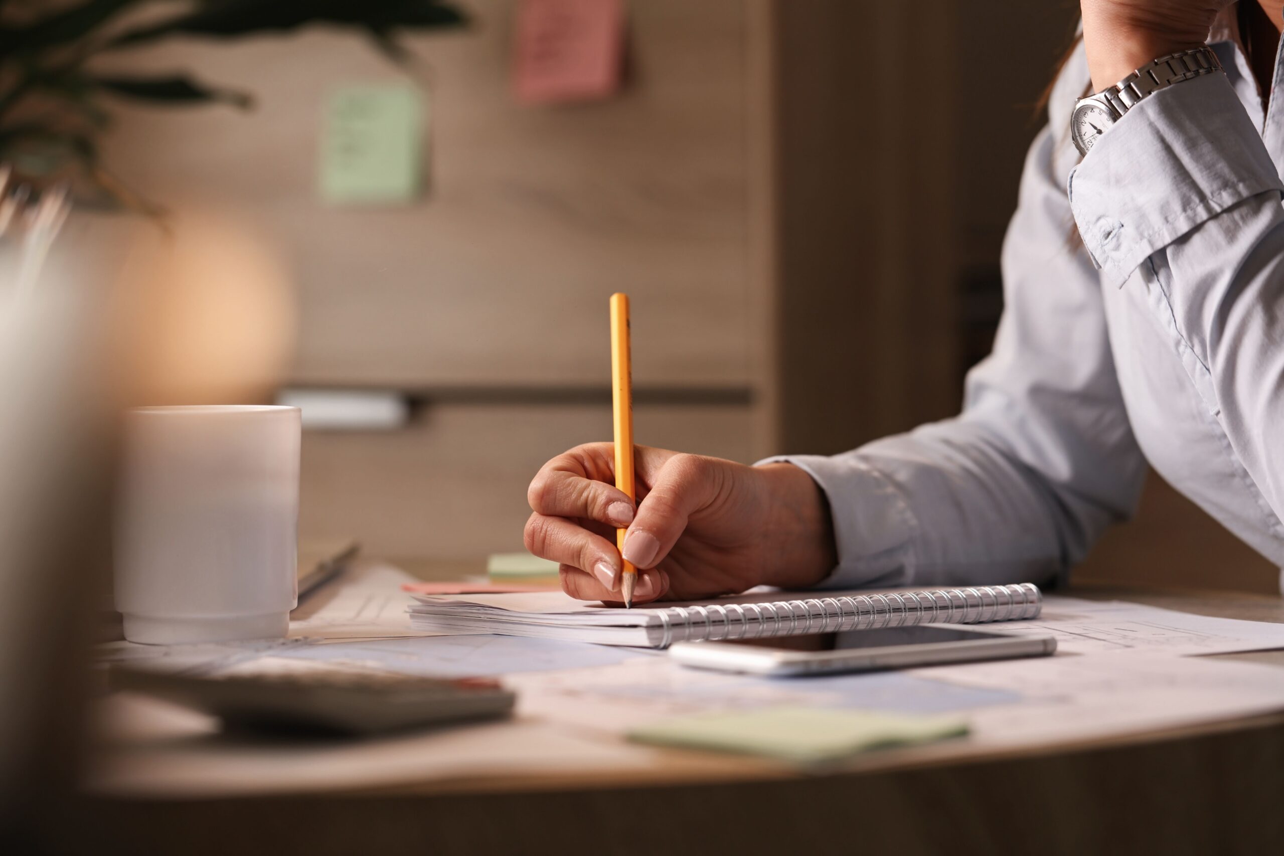 unrecognizable-businesswoman-working-office-writing-business-plans-her-notebook (1)