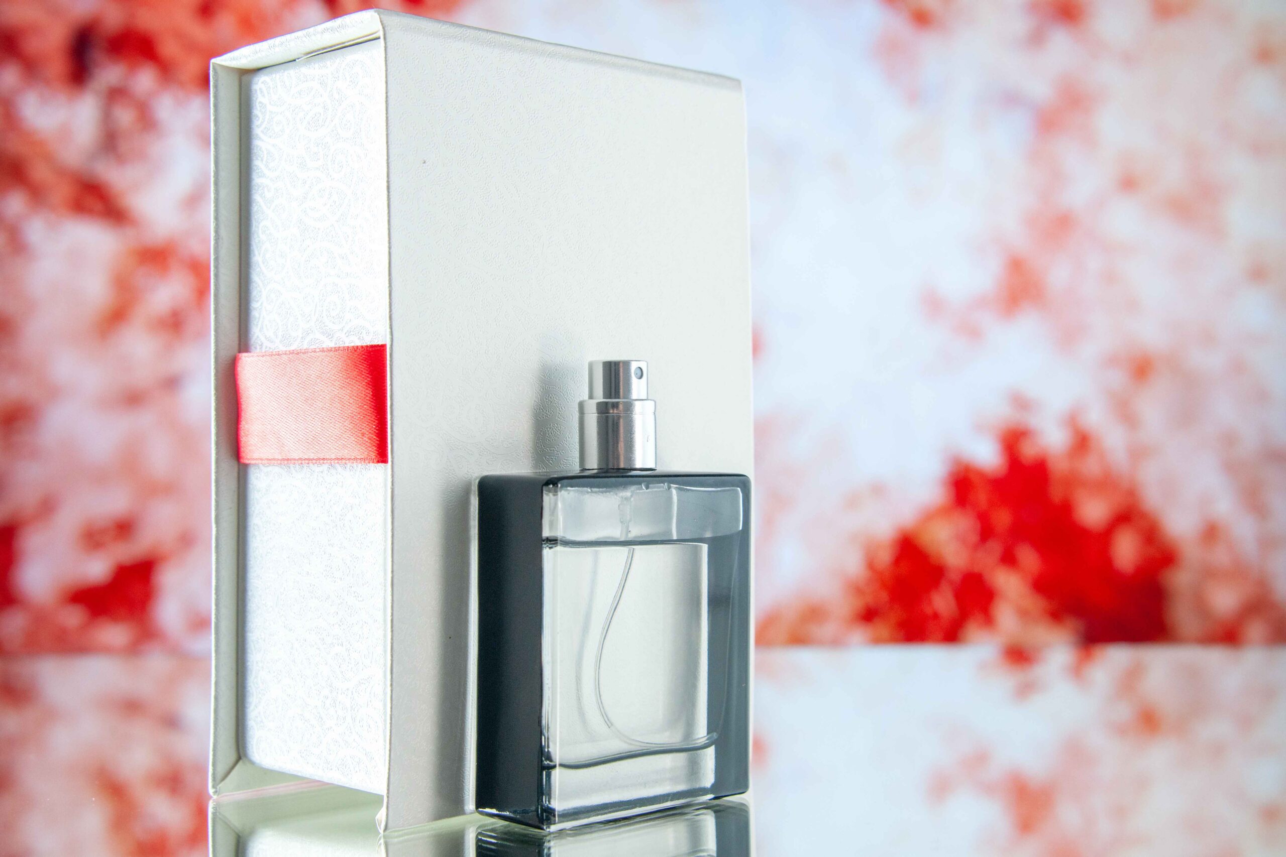 front-view-expensive-perfume-as-present-light-red-table_11zon