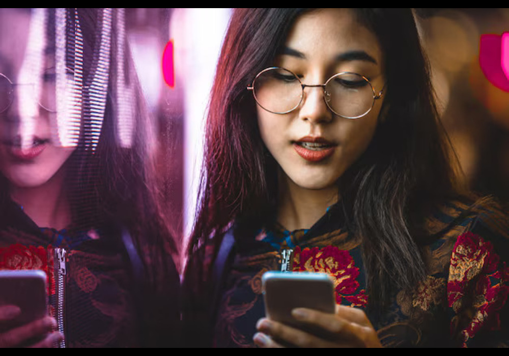 smiling-young-woman-using-smart-phone-by-window-with-reflection-night_1048944-12391547 (3)